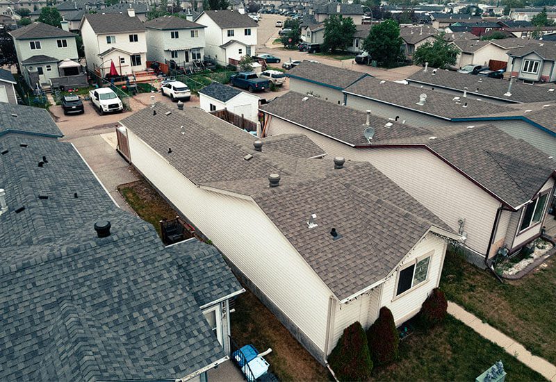 Aerial view of residential homes with well-maintained rooftops.