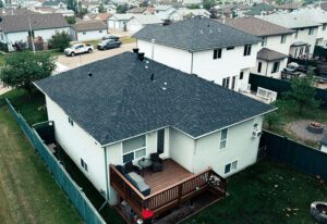 Snow-covered suburban neighborhood with two-story house in the foreground.